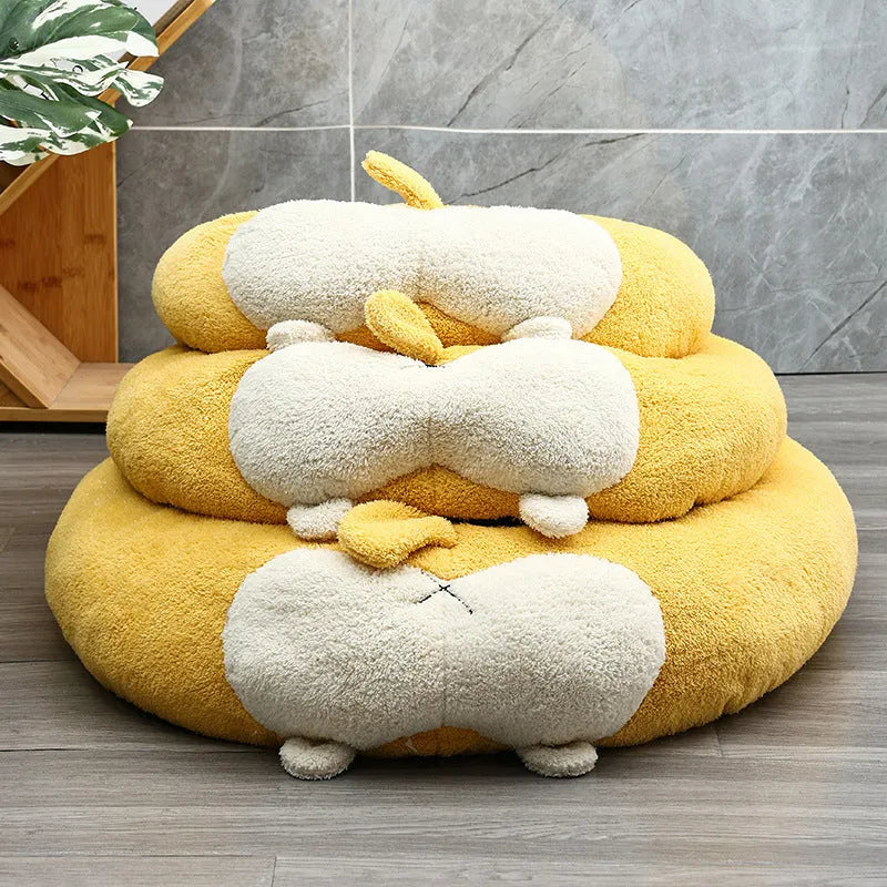 Corgi-shaped plush pet bed for dogs and cats in grey, shown in a home setting.