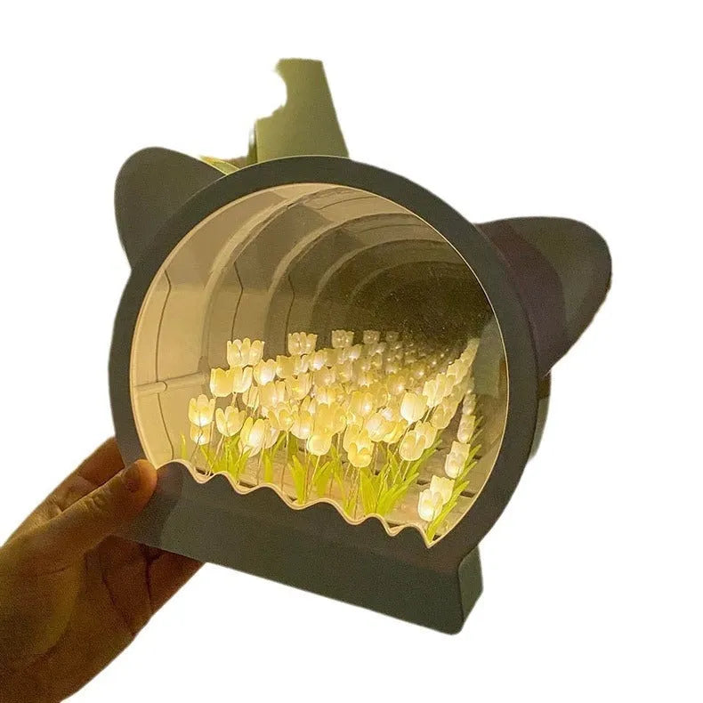 Handmade DIY cat head shaped night lamp decorated with pink tulip flowers on a dark background