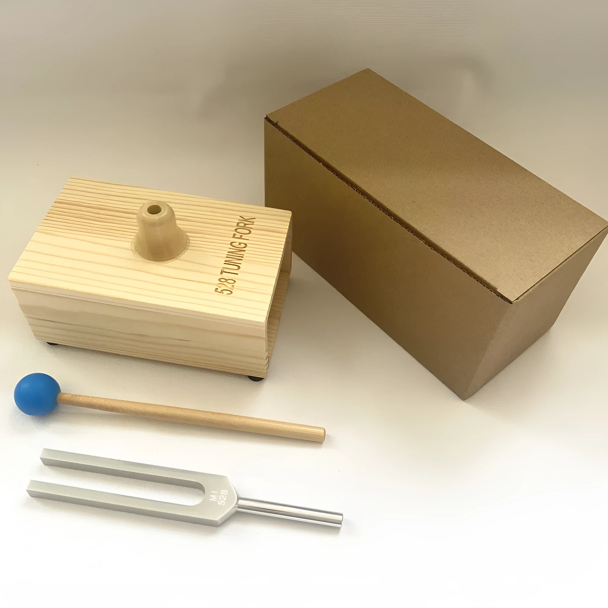 Aluminium alloy 432Hz tuning fork and speaker set on kraft paper box