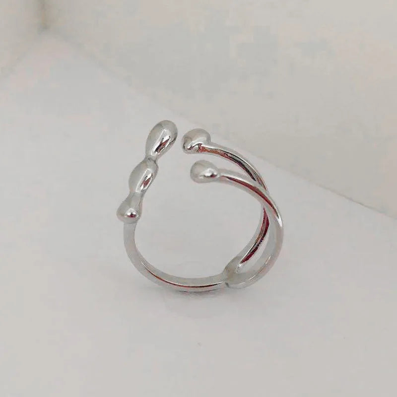 Brass opening ring with spherical elements in gold or silver colour for women's jewellery