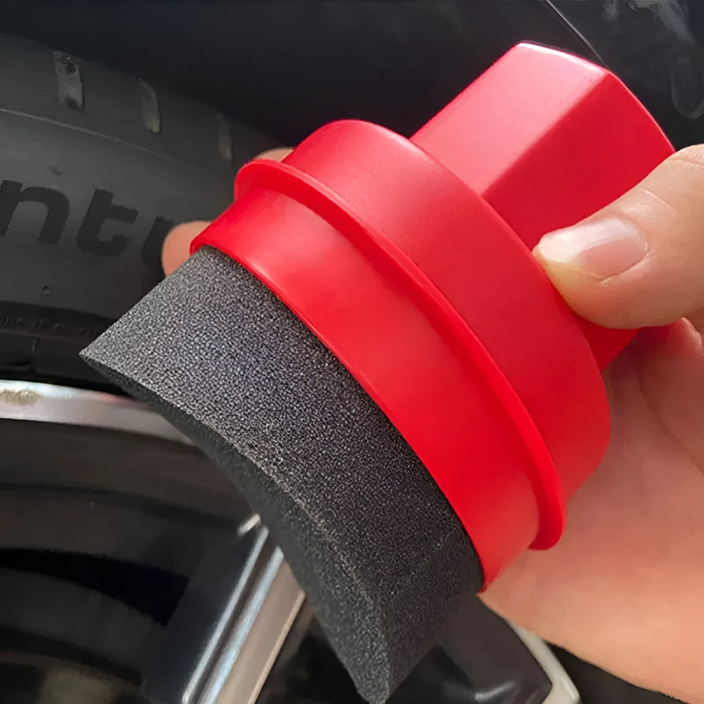 Black and red tyre polishing sponge brushes with protective lids on a white background