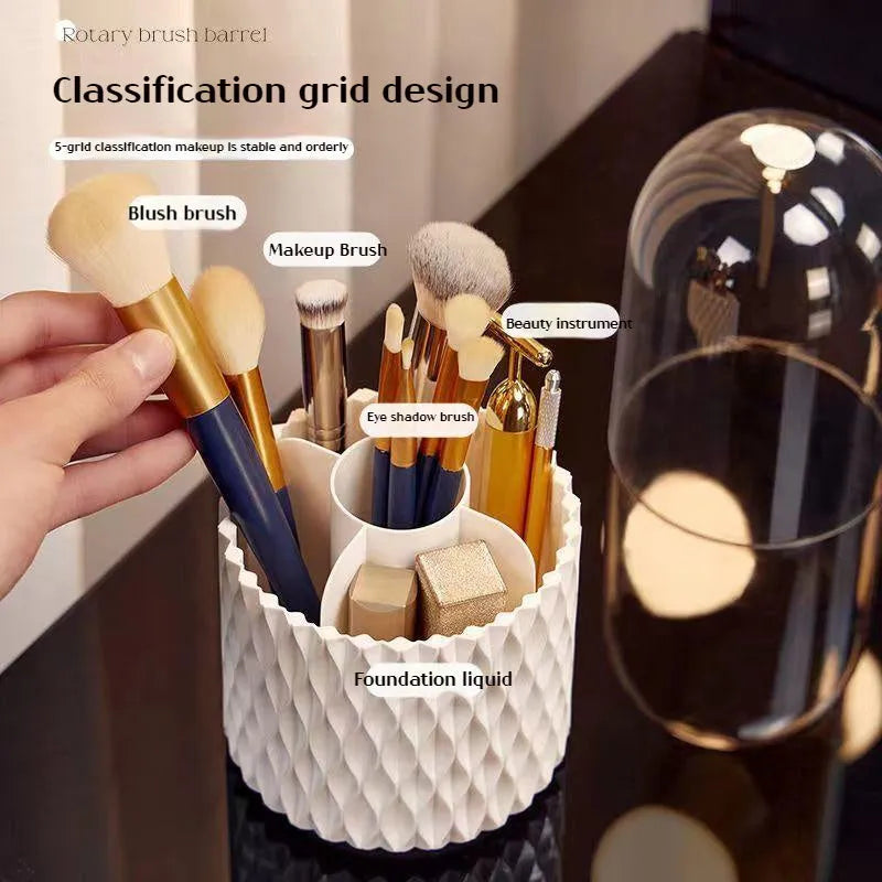 White acrylic rotating makeup brush holder with transparent body and a grey dust cover on a desk.