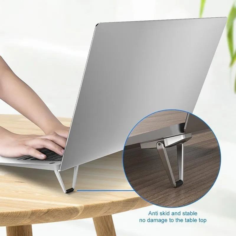 Compact foldable aluminium laptop stand bracket in silver and white with 3M adhesive pads