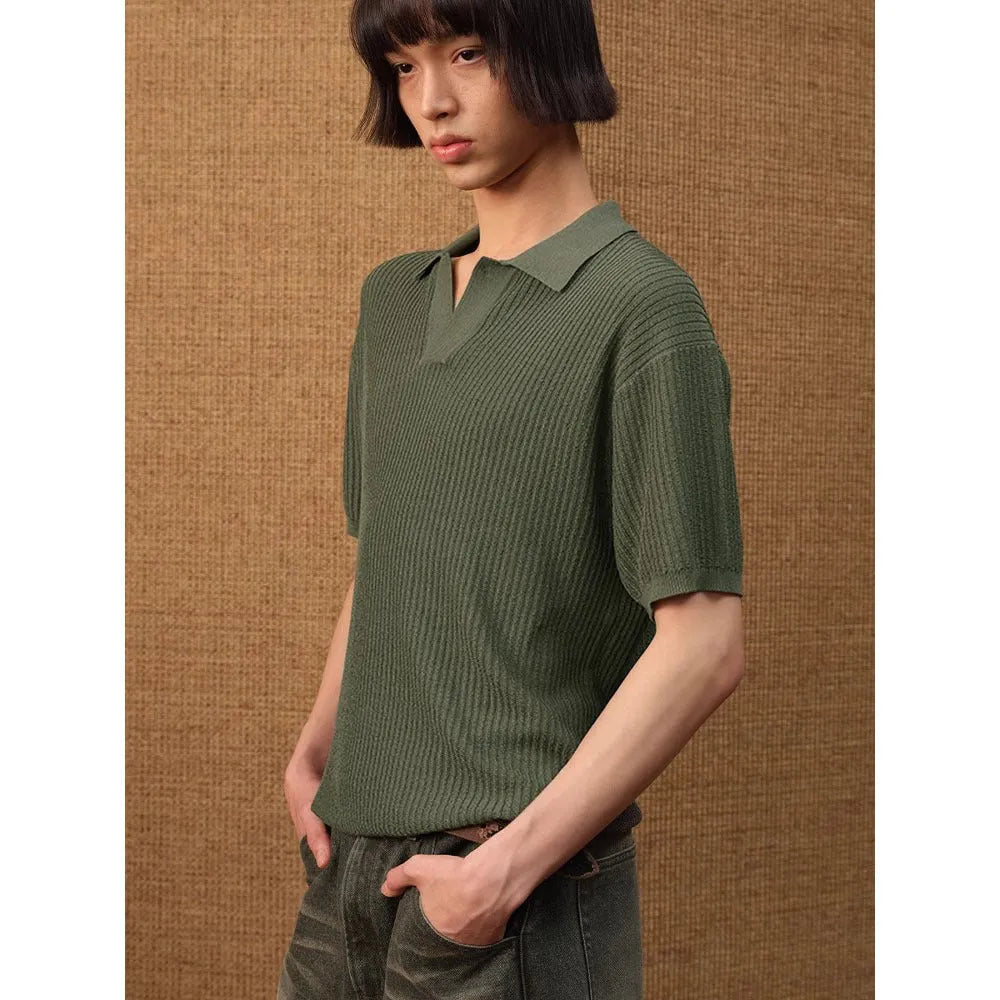 A creamy-white loose-fit polo shirt with a striped collar and short sleeves on a hanger.