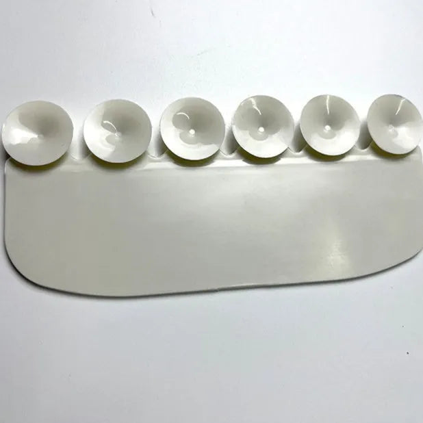 White PVC toilet training splash guard placed on a toilet seat.