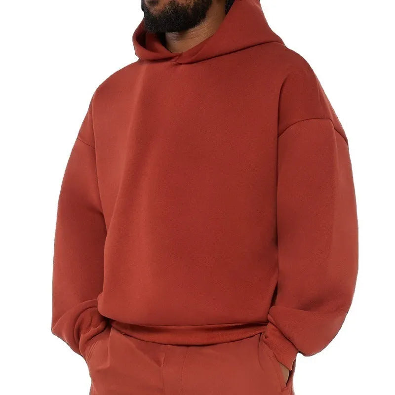 A man wearing a solid colour fleece-lined cotton hoodie with a wool lining.