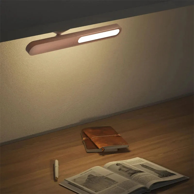 White geometric desk lamp with magnetic suction base and touch control on wooden desk