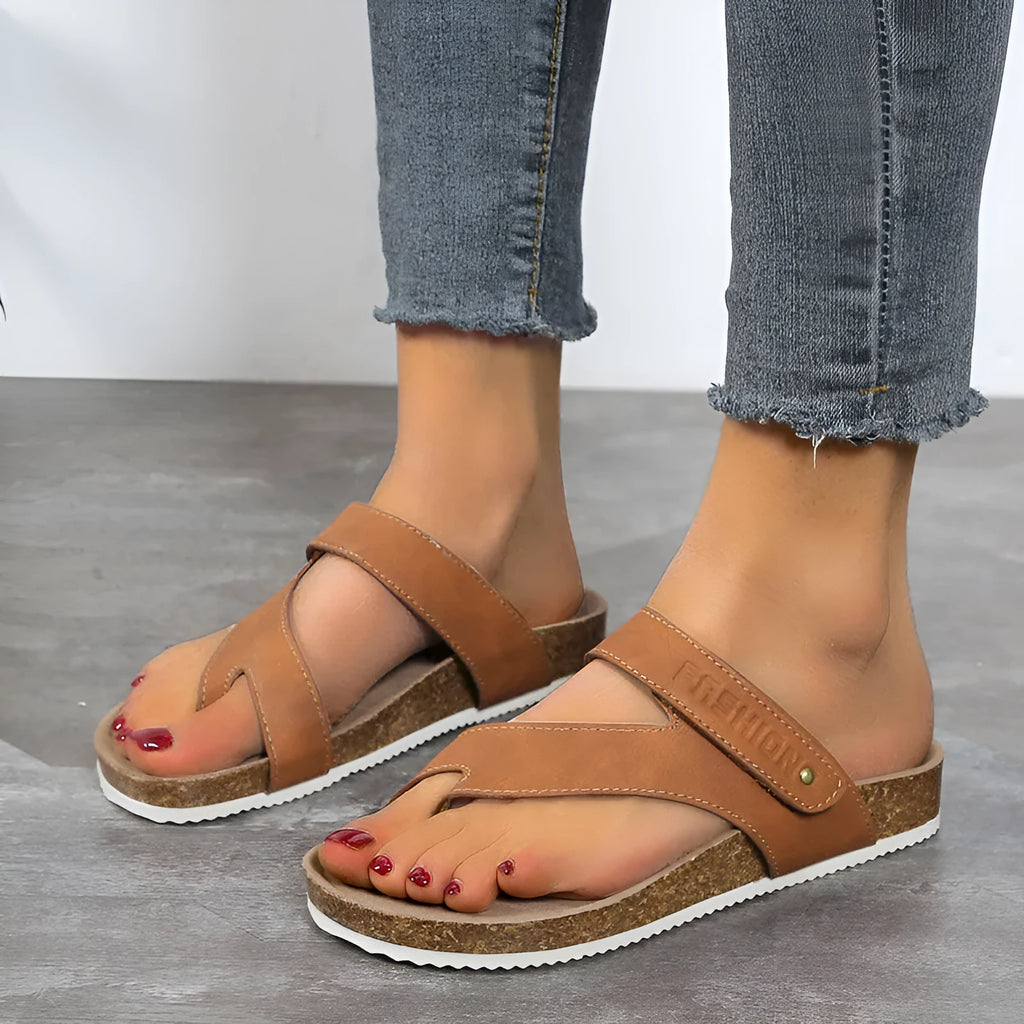 Blue thick-soled flat flip-flops with a toe ring on a foam sole.