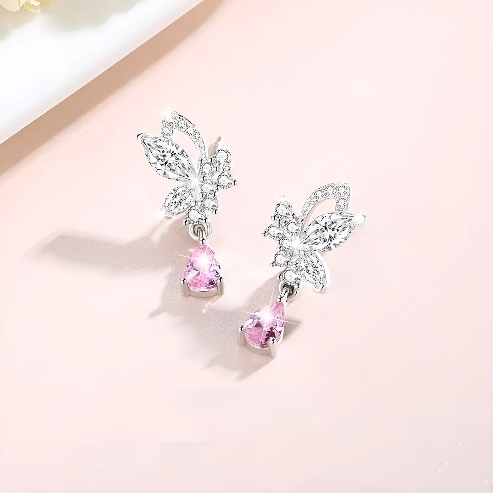 Sterling silver butterfly stud earrings with crystal details on woman's earlobe