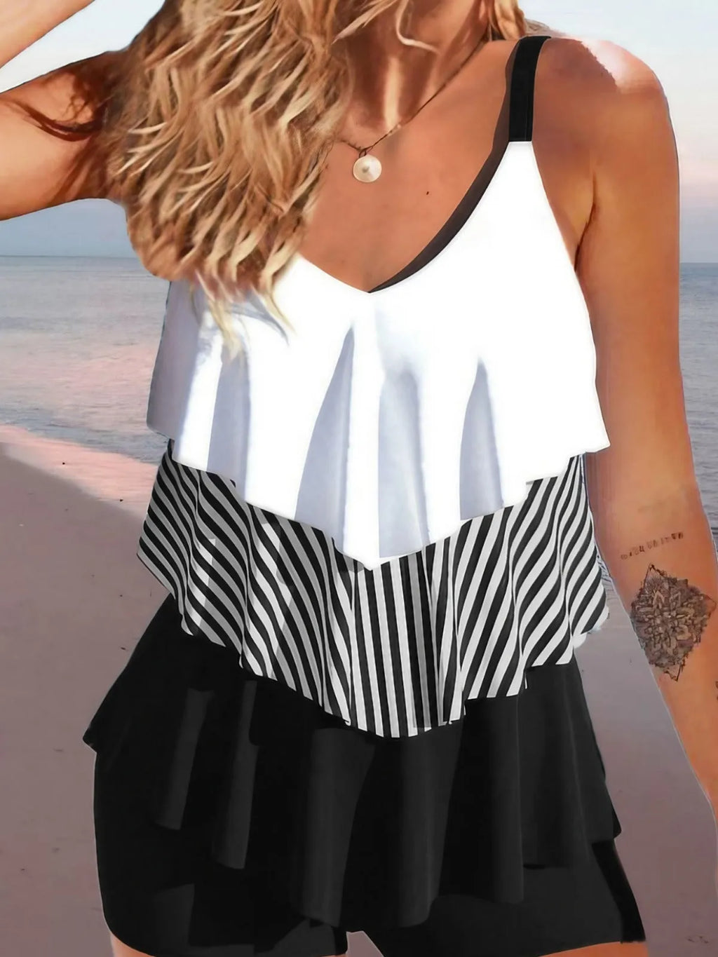 Women's sleeveless backless bikini with ruffles and spaghetti straps, shown in a floral print.