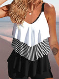 Women's sleeveless backless bikini with ruffles and spaghetti straps, shown in a floral print.