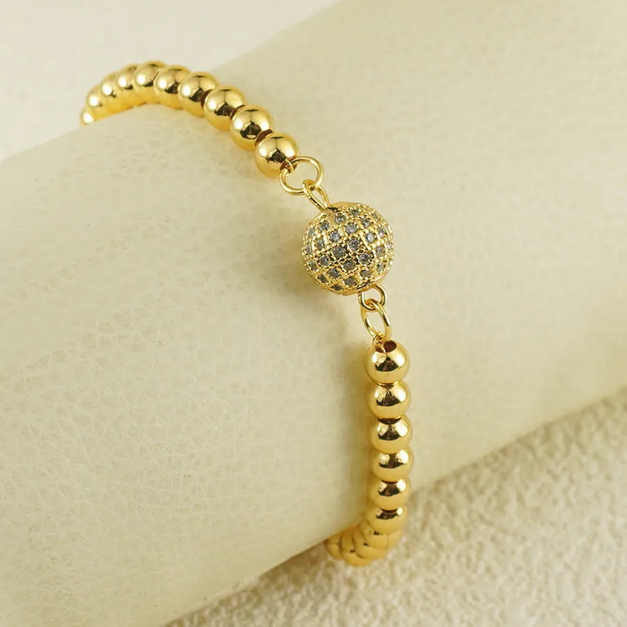 Copper bracelet with heart-shaped Arabic design and single zircon centrepiece on white background