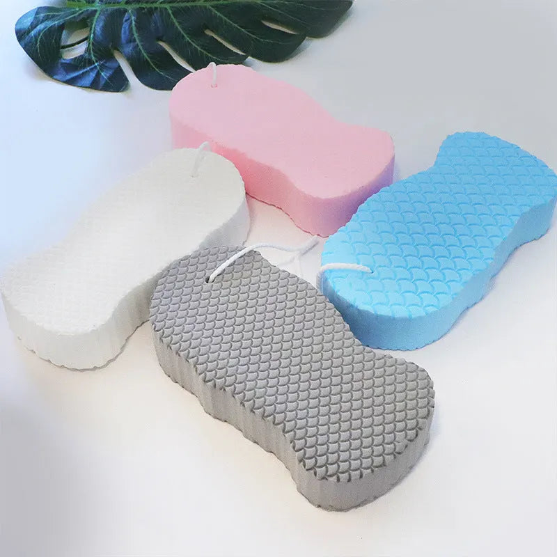 3D white bath sponge with fish scale pattern for gentle body exfoliation.