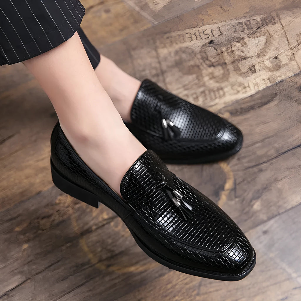 Men's black slip-on shoes with pointed toe and tassel decoration on artificial PU upper