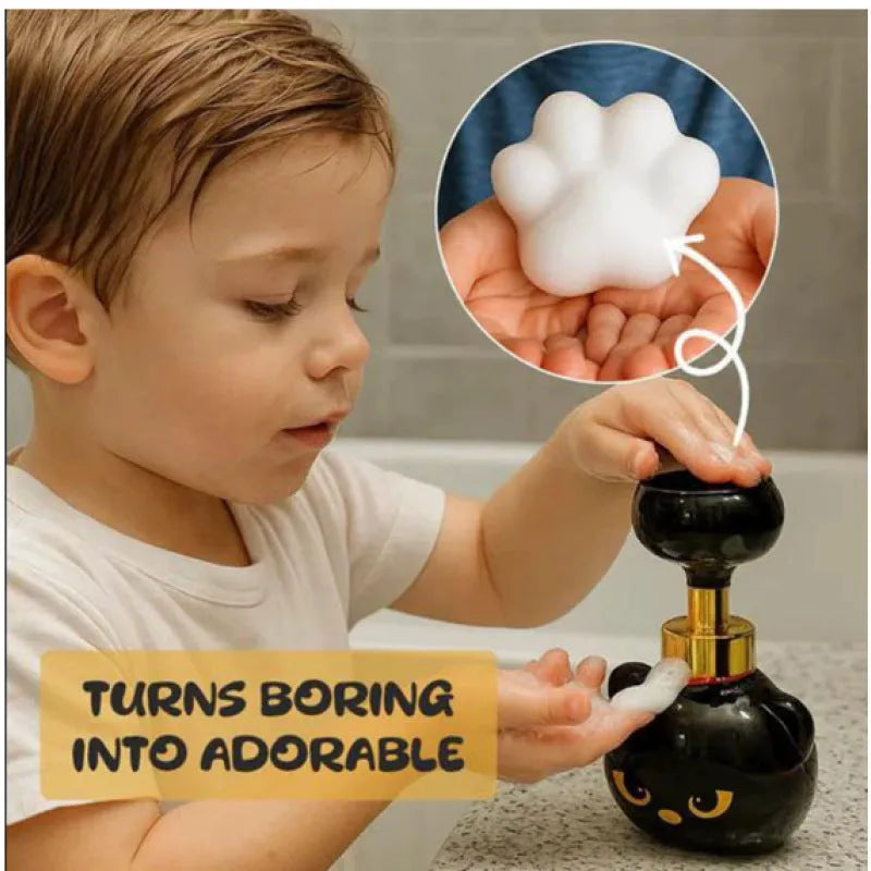 Black plastic cartoon cat-shaped foam soap dispenser on a counter.