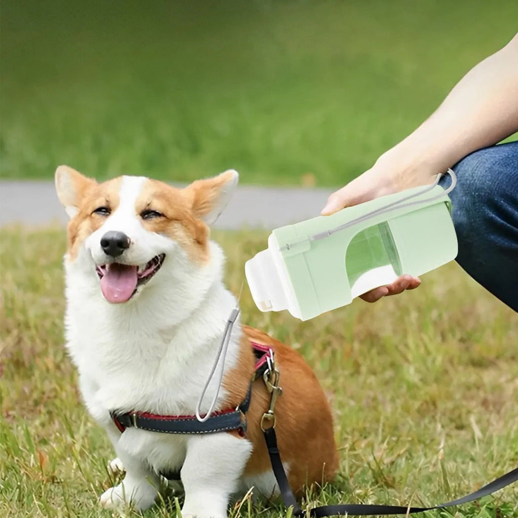 Grey foldable 2-in-1 dog water bottle and feeder with lanyard, showing food and water compartments.