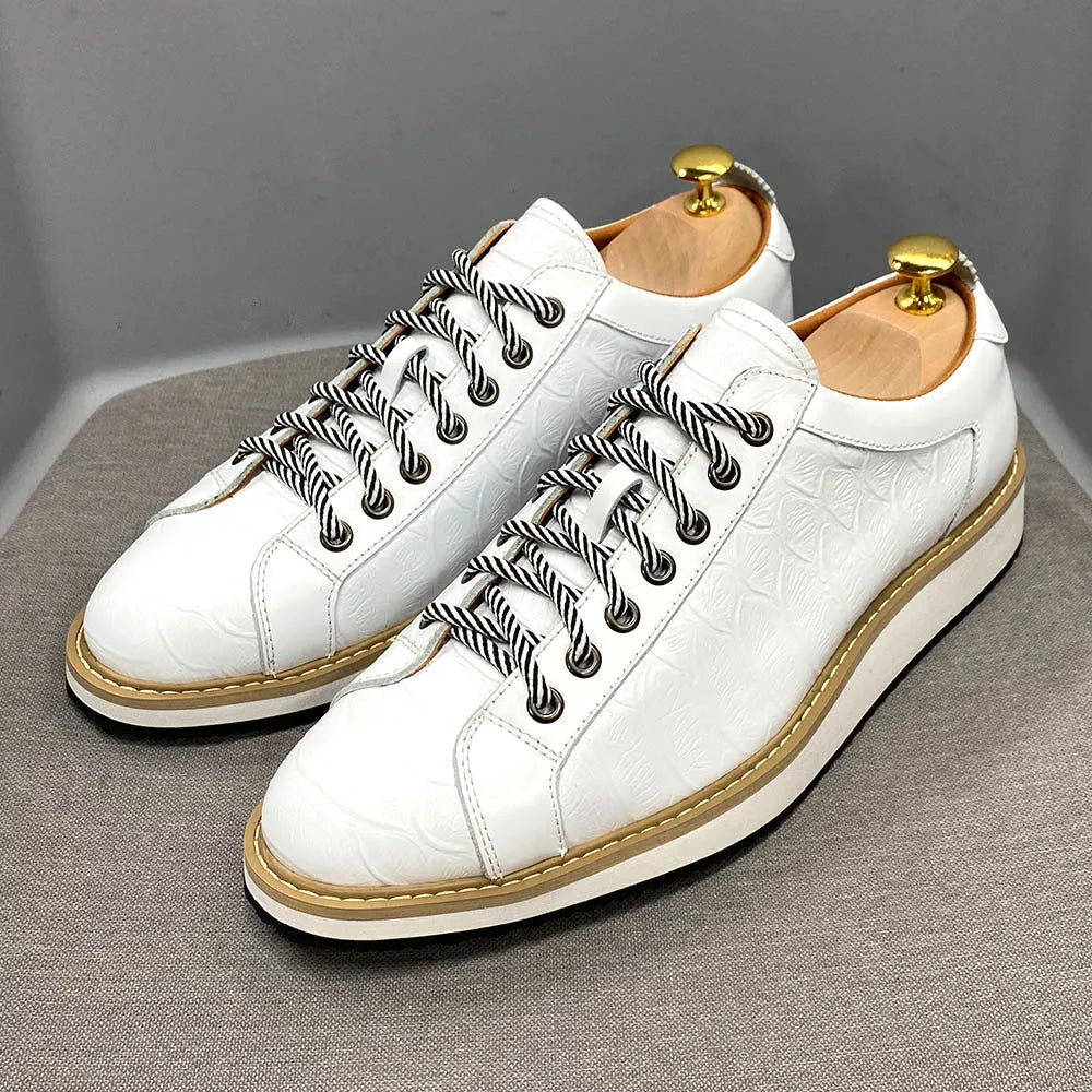Men's low-top handmade shoes with embossed pattern and front-tie laces.