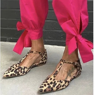 Women's leopard print pointed toe pumps with a low chunky heel and ankle straps.