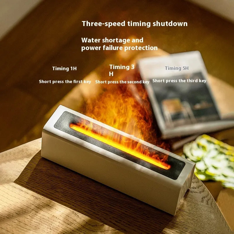 Black square USB aroma diffuser with colourful flame light effect and mist output on a wooden table.