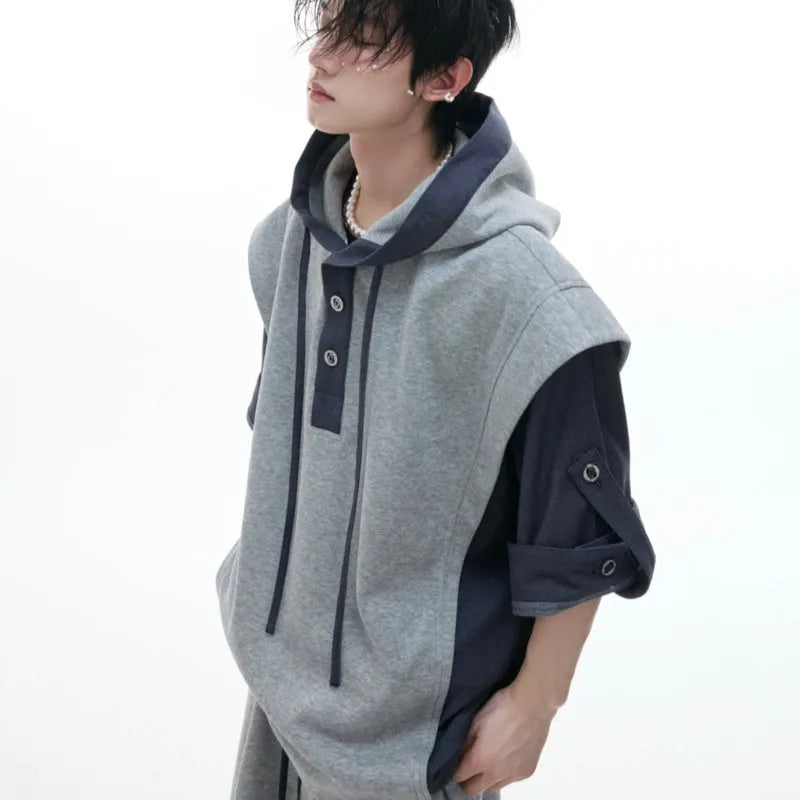 Man wearing a gray hooded short-sleeve sports jacket with 3D stitching and black matching trousers.
