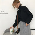 Women's apricot coloured half-high collar long sleeve loose fit casual top on a hanger