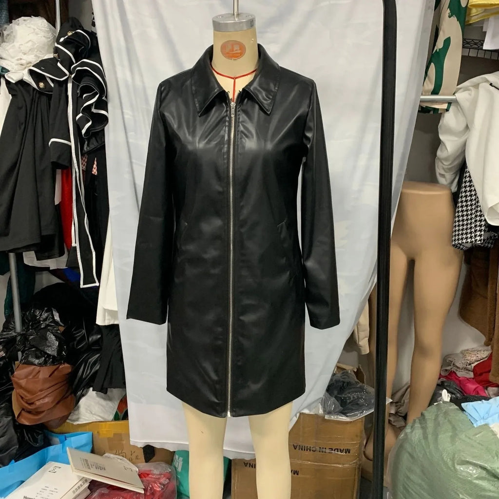 Women's solid black medium-length leather jacket with long sleeves laid flat.