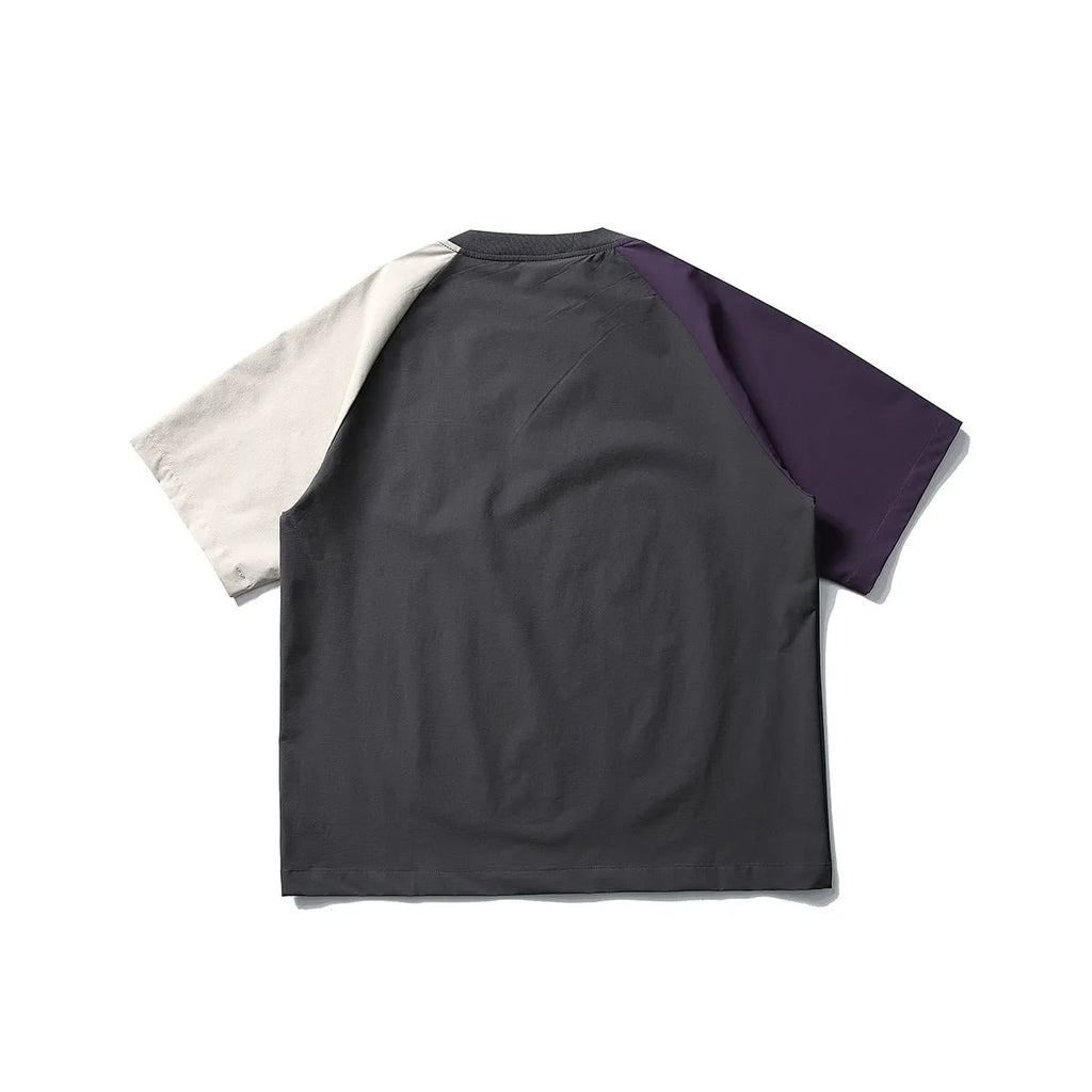 Dark grey men's loose fit t-shirt with contrasting colour raglan sleeves on a hanger.