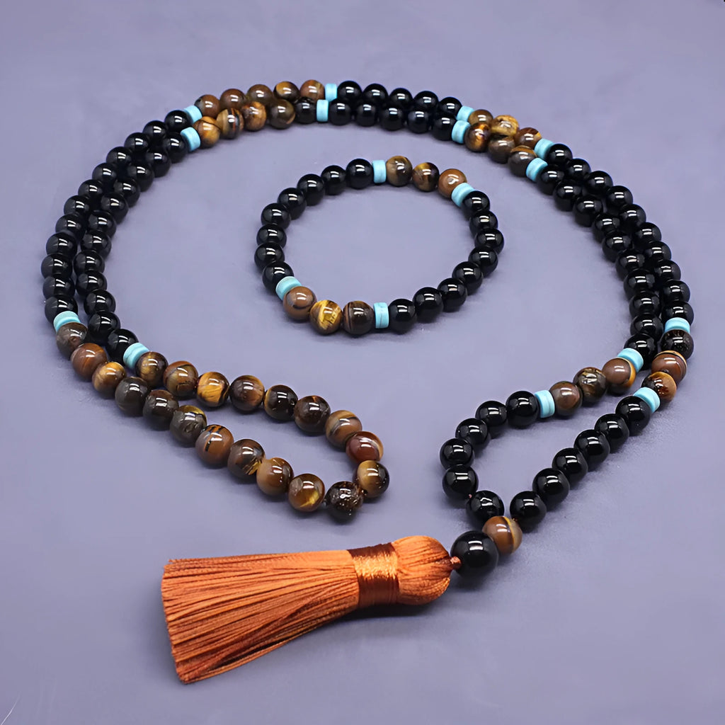 Black agate bracelet and matching tiger's eye geometric necklace set on a plain background.