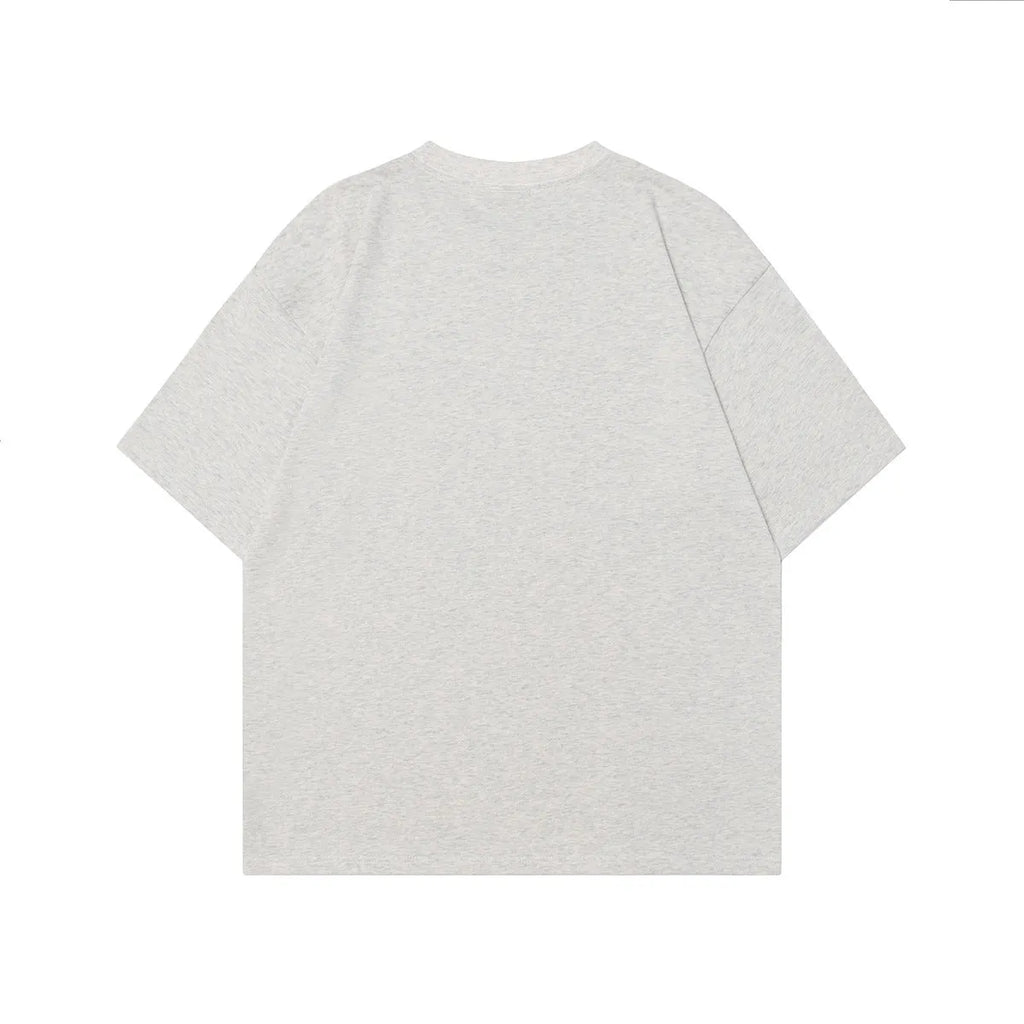 Men's loose-fit grey cotton T-shirt featuring a retro graphic character print on the chest.