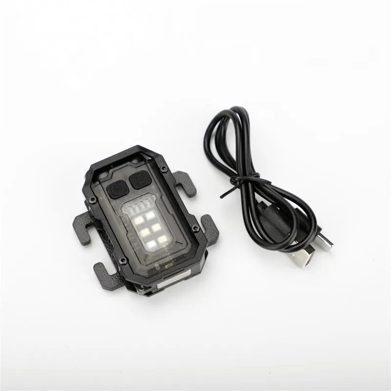Portable red tactical warning flashlight with USB charging cable for backpack mounting.
