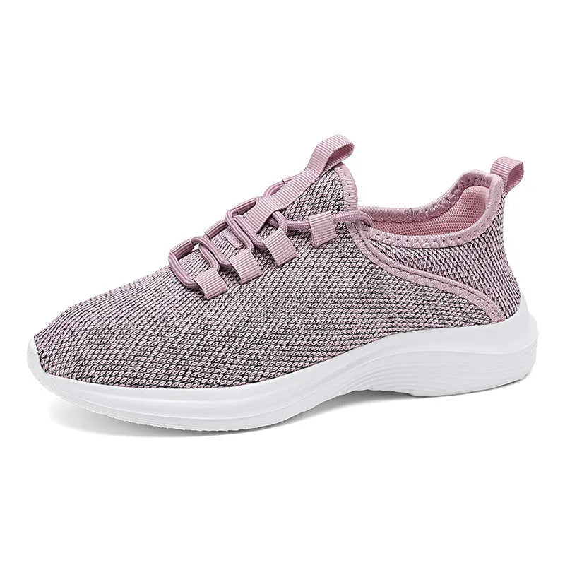 Women's low-top black casual sneakers with mesh upper and lace-up front on a grey background.