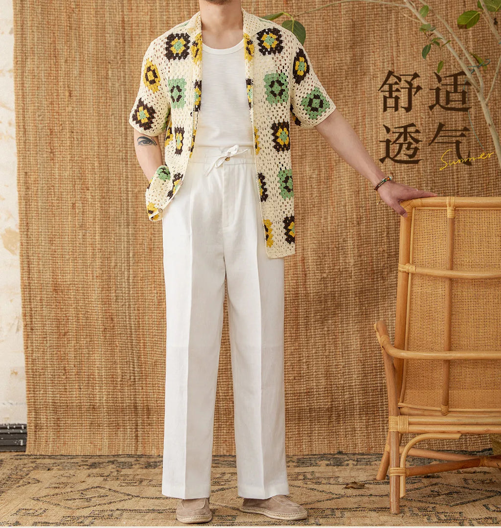 Linen high waist trousers with elasticated waistband in a straight-leg fit on a hanger.