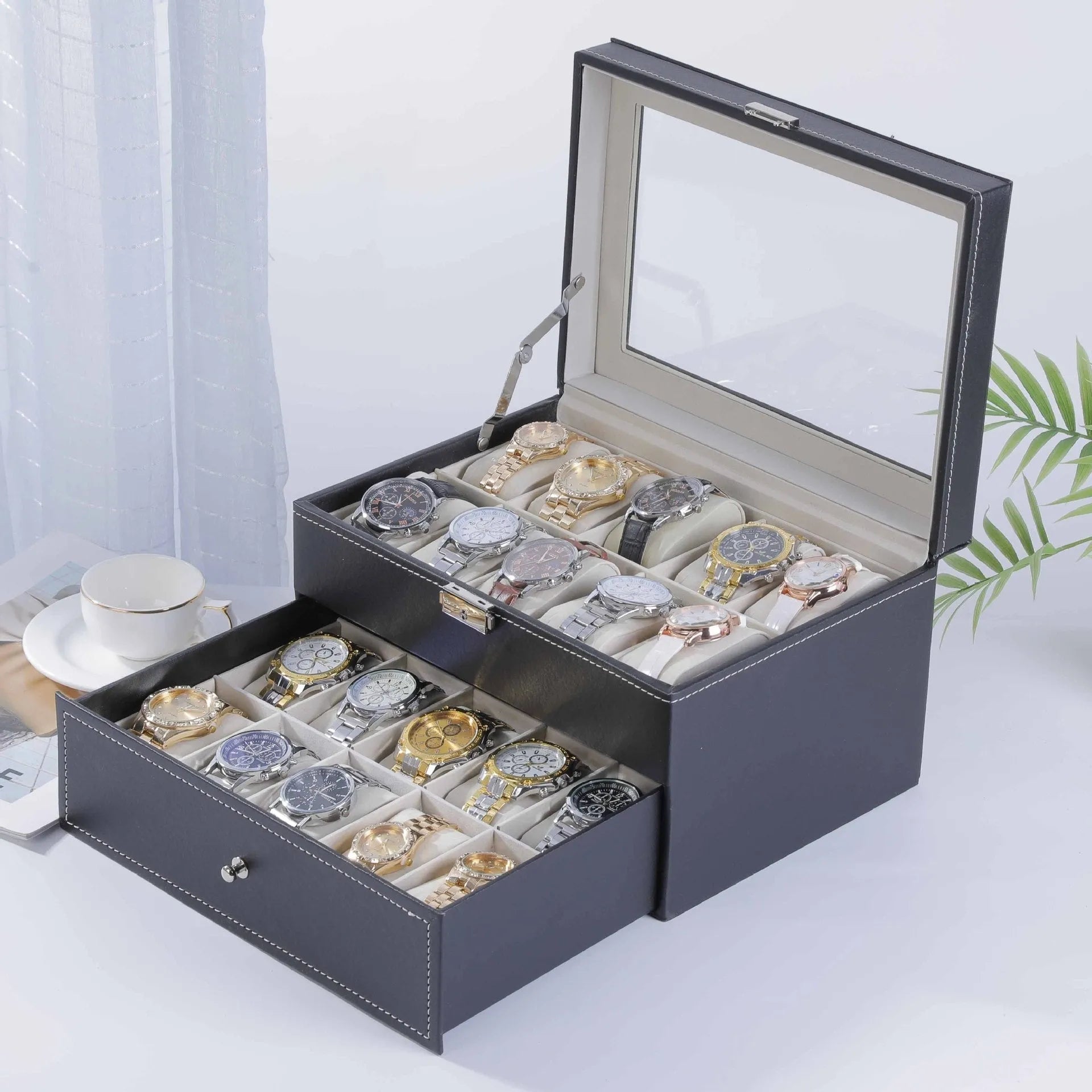 Grey leather watch storage box with clear dustproof lid showing multiple watch compartments inside.