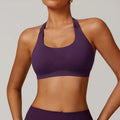 Women's black halter yoga bra with hollow design and built-in chest pads on a mannequin.