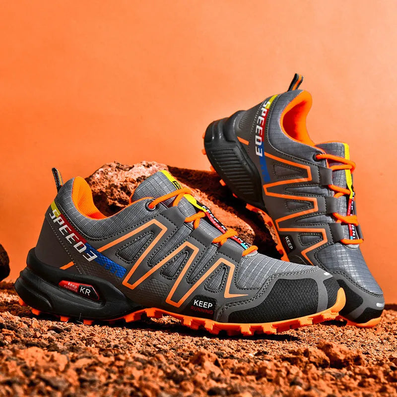 Men's low-top casual shoe in synthetic leather with a mesh lining and rubber sole, shown in grey orange colour.