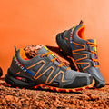 Men's low-top casual shoe in synthetic leather with a mesh lining and rubber sole, shown in grey orange colour.