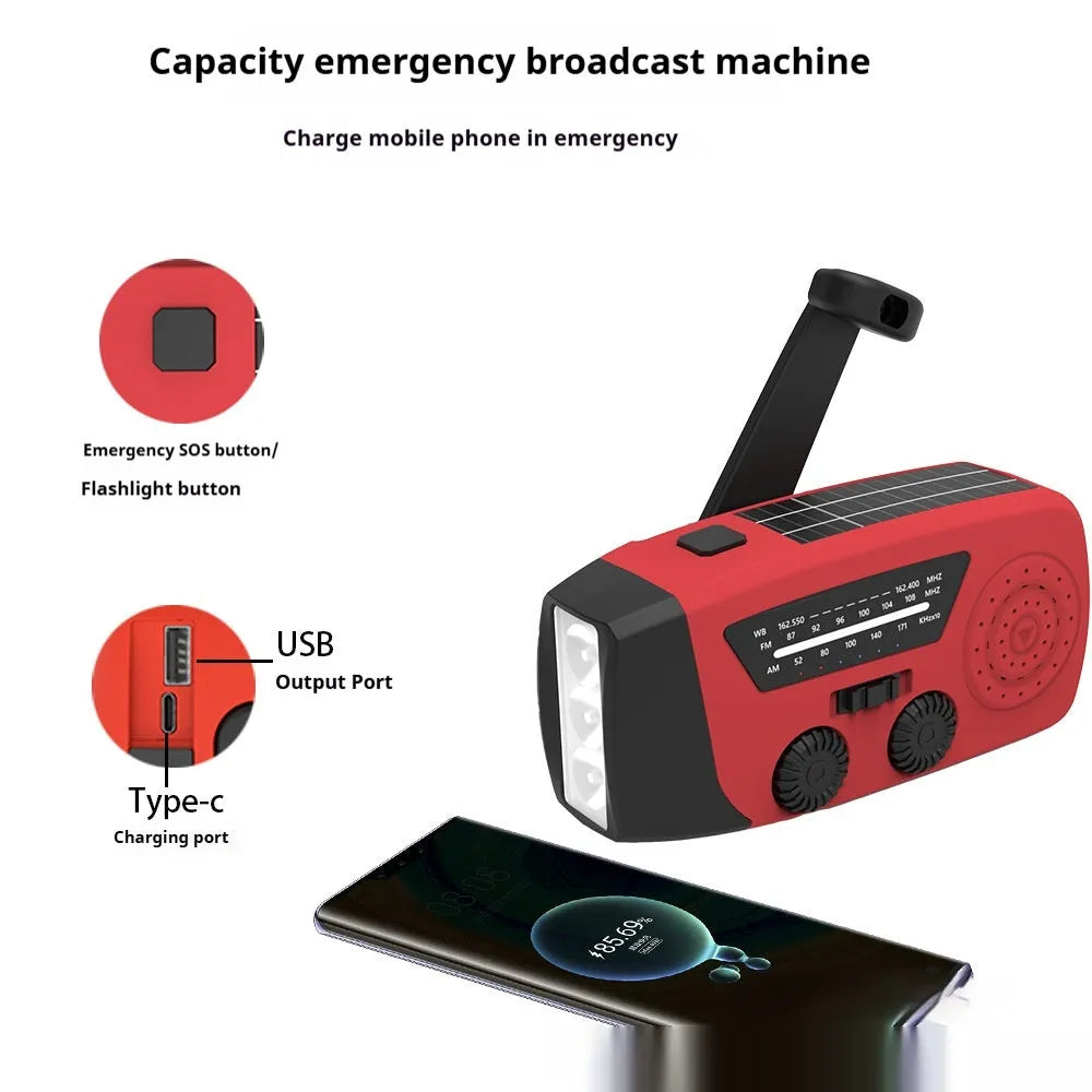 Red rechargeable emergency hand crank radio torch with USB port and wrist strap