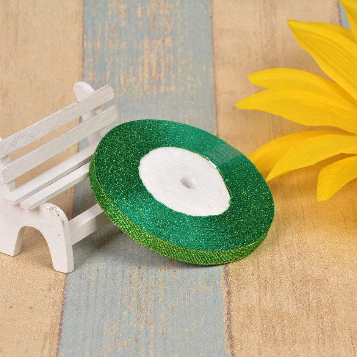 Green onion coloured polyester ribbon with gold polka dots on 25-yard spool for decorative trimming