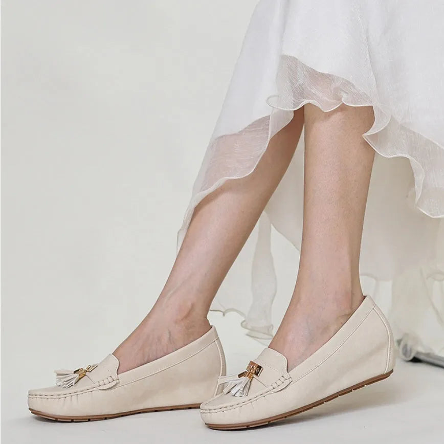Nude coloured heel height increasing insole with round toe for flat shoes.