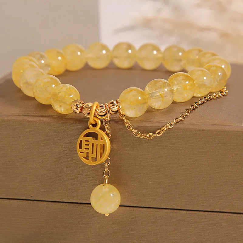 Adjustable natural citrine gemstone bracelet with selectable Chinese 'Cai' or 'Fu' character charm and tassel.