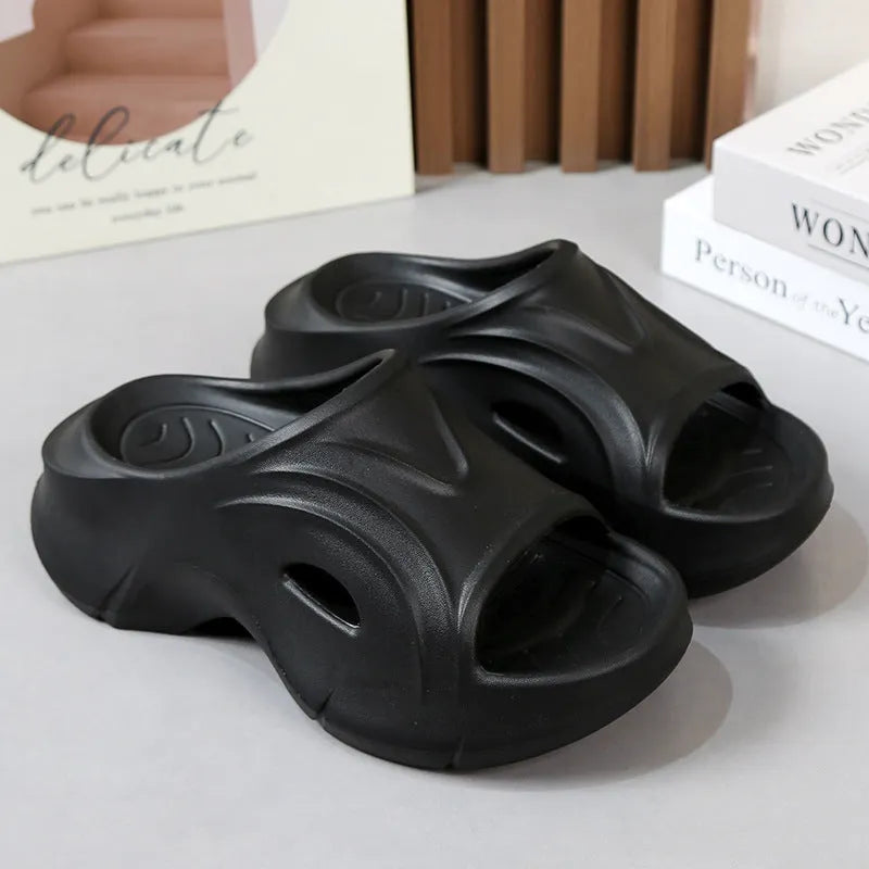 White women's EVA slippers with thick sole and round toe on a beach background.