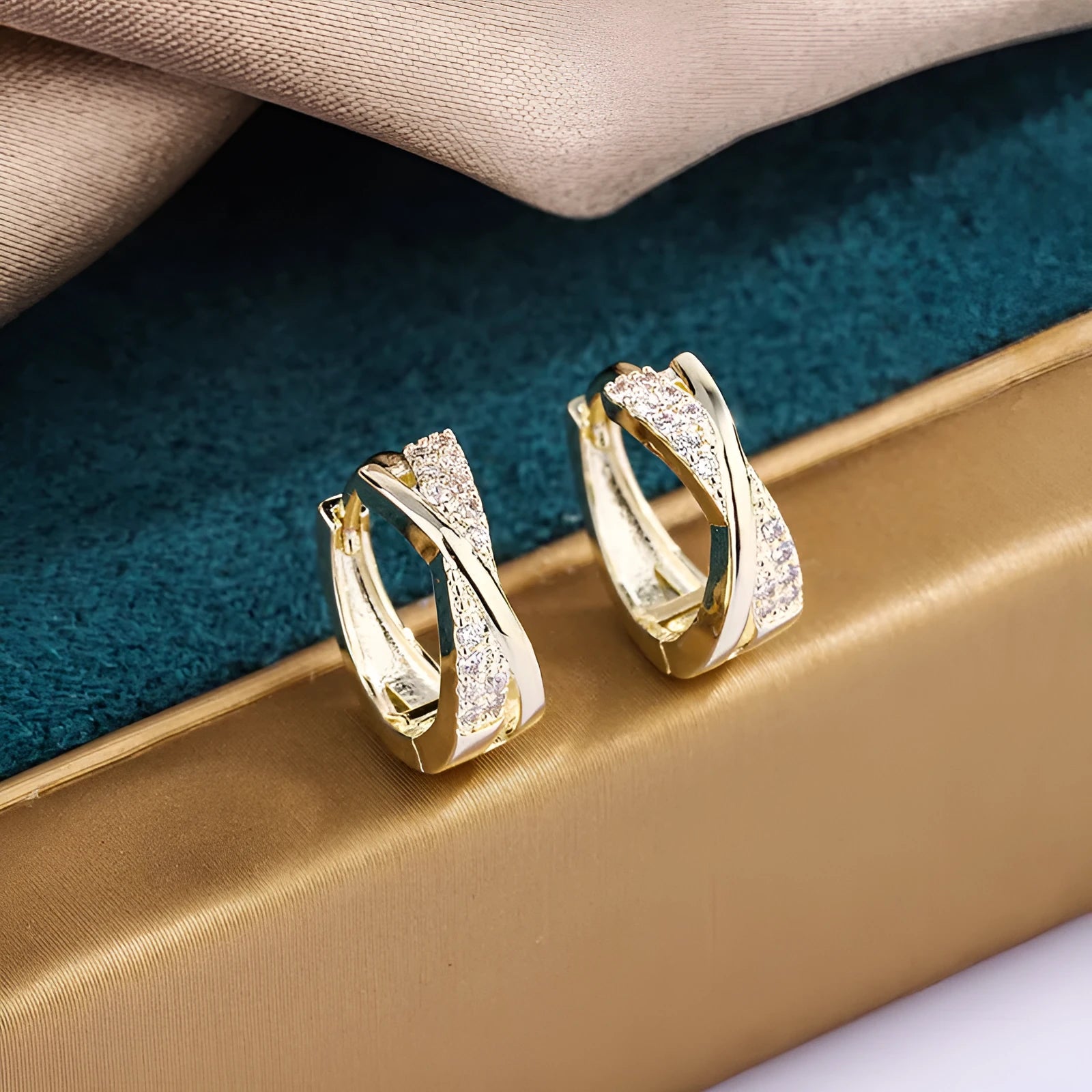 Pair of geometric drop earrings in 14K yellow with zircon treatment on a copper base.