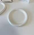 White porcelain plate with cute bear doodle design, 20cm size, on a table.