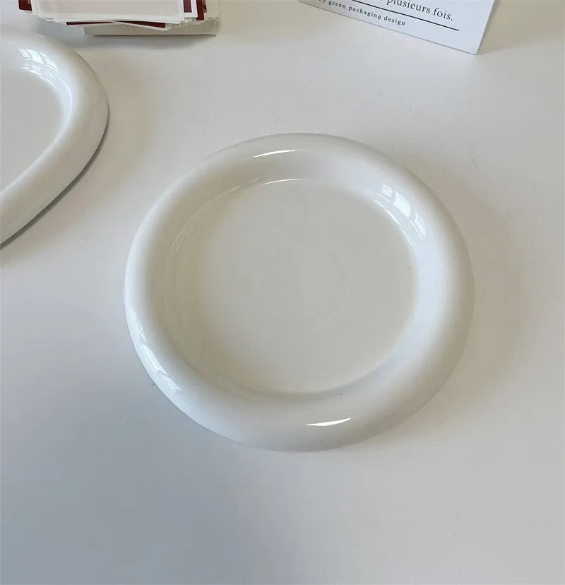 White porcelain plate with cute bear doodle design, 20cm size, on a table.