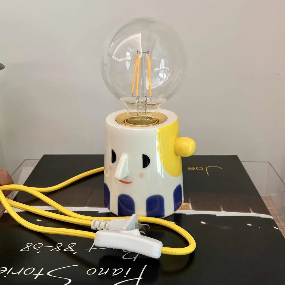 Handmade ceramic lamp with ball headlight design on bedside table