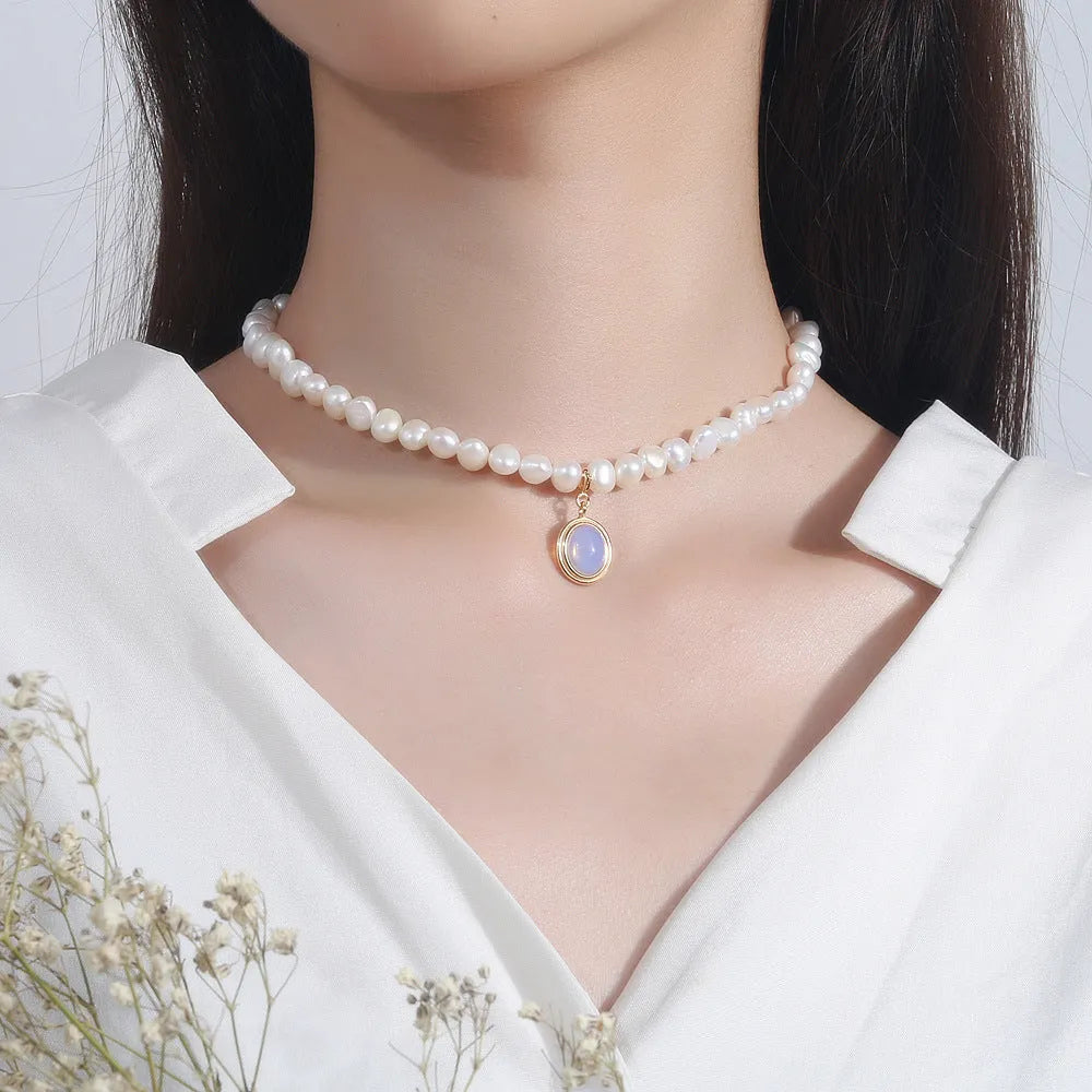 Geometric pearl silver necklace with irregular pearls and adjustable length on white background