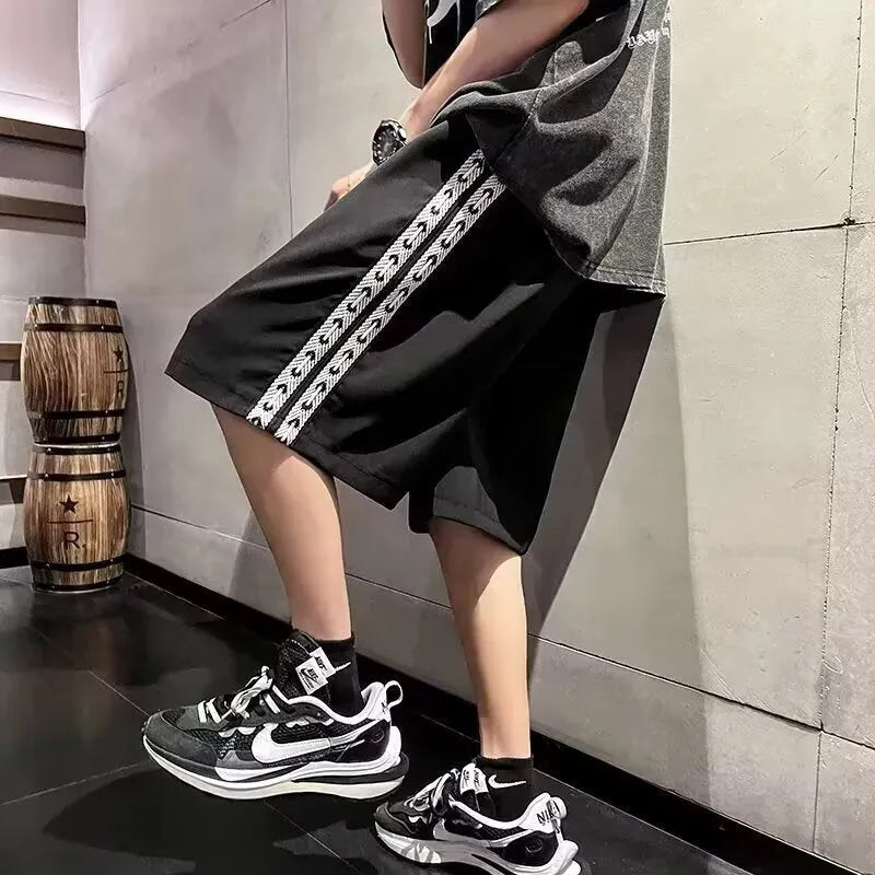 Men's black baggy track pants with loose fit and elastic waistband