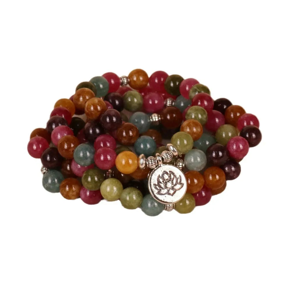 108-bead multi-layer alloy bracelet in a tourmaline colour, shown hanging and as worn jewellery.