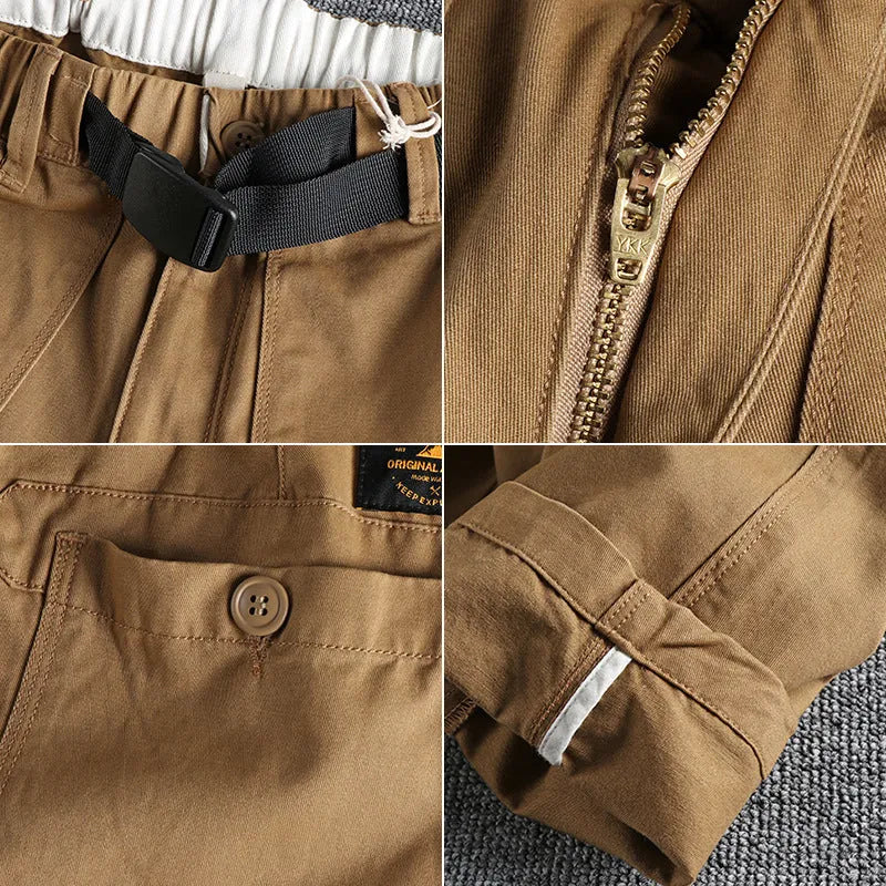 Men's khaki cotton work trousers with a matching N I buckle belt, showing three-dimensional cutting and a zipper fly.