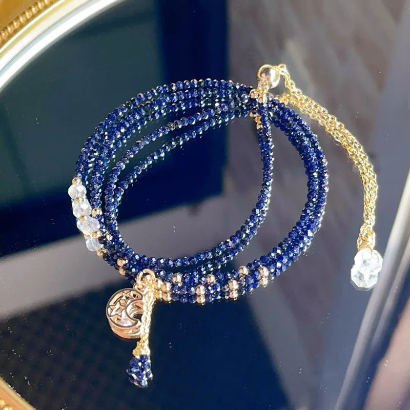 Blue sand stone three-ring multi-layer bracelet for women on a wrist.